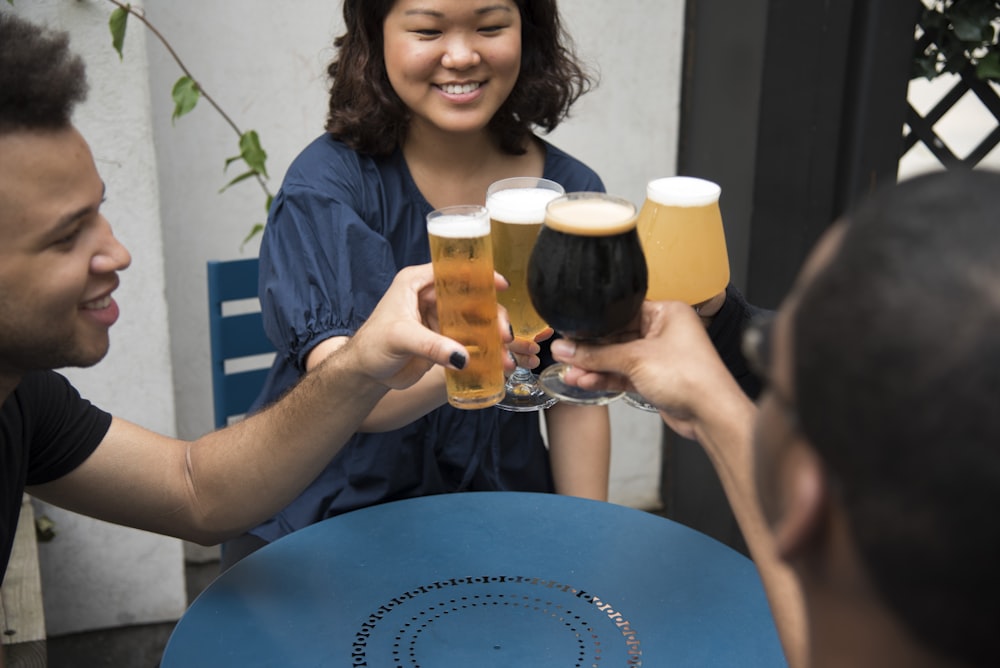 four person's holding wine glasses