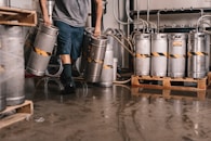 person carrying keg tanks