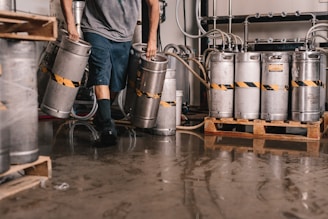 person carrying keg tanks