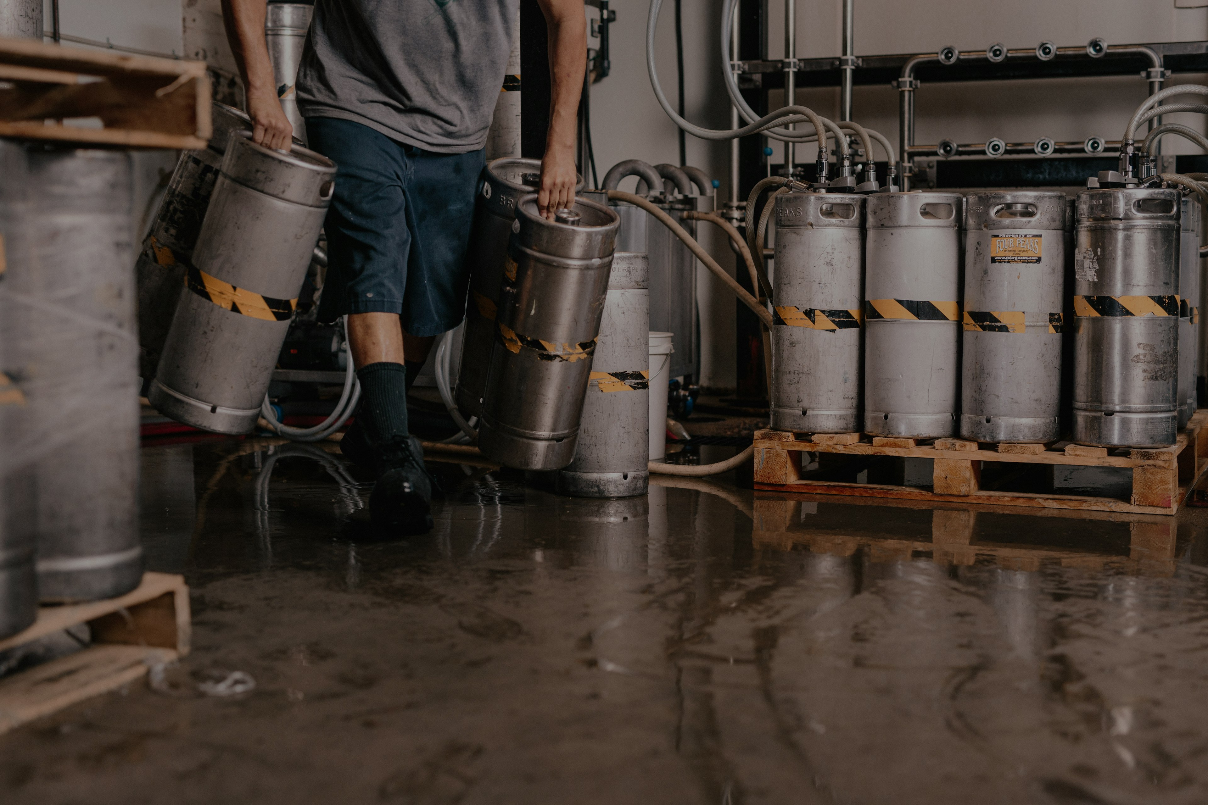 person carrying keg tanks