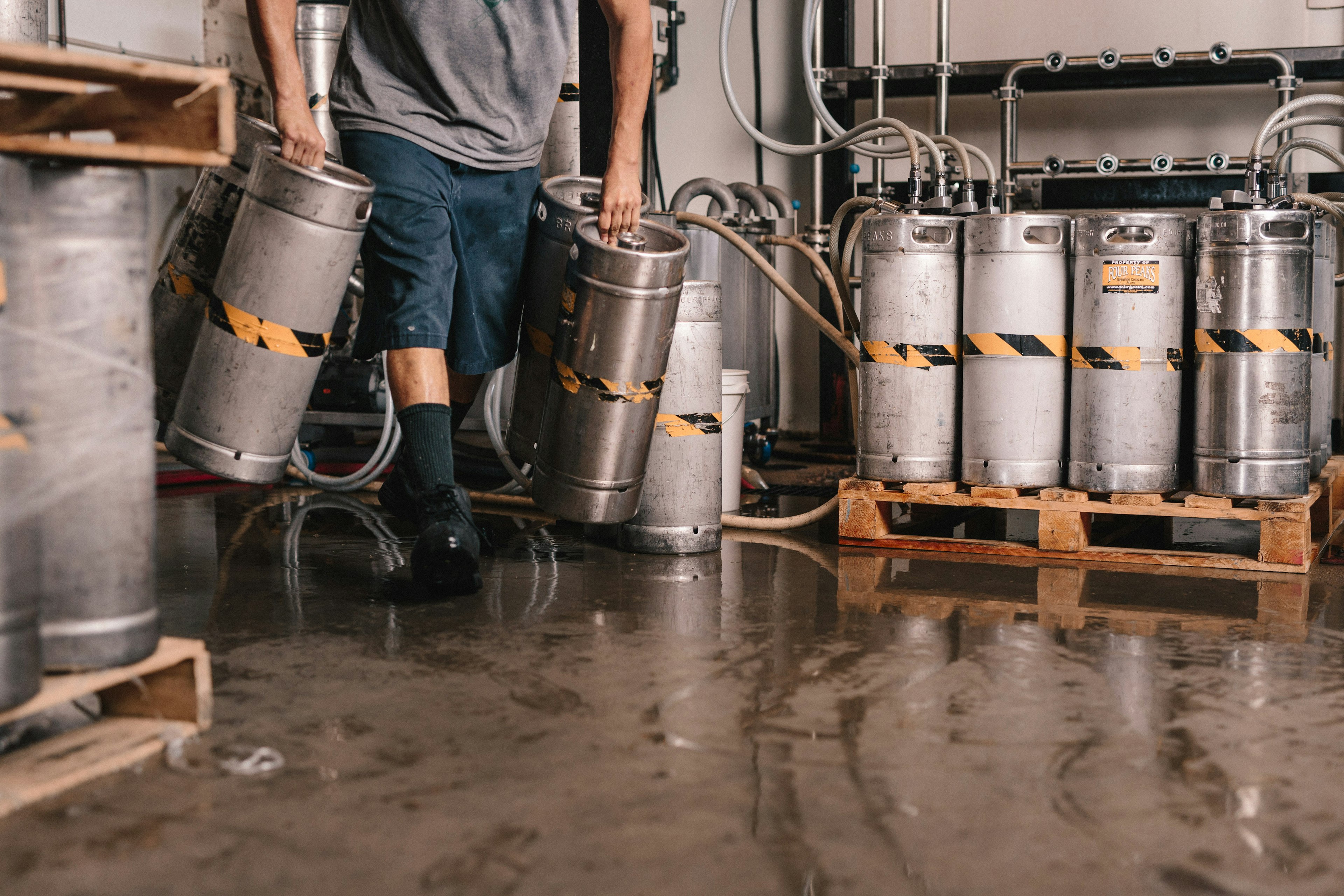 person carrying keg tanks