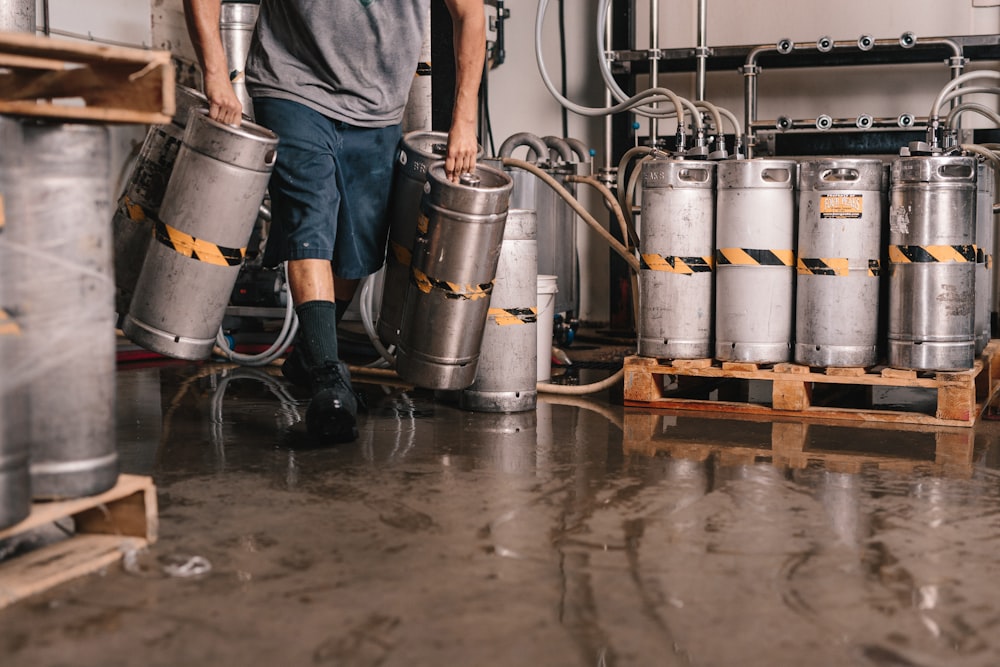 person carrying keg tanks