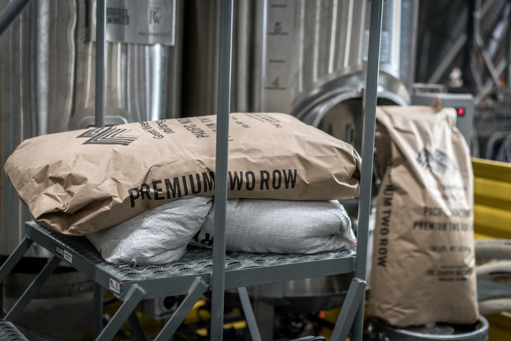 brown and white sacks on gray metal ladder