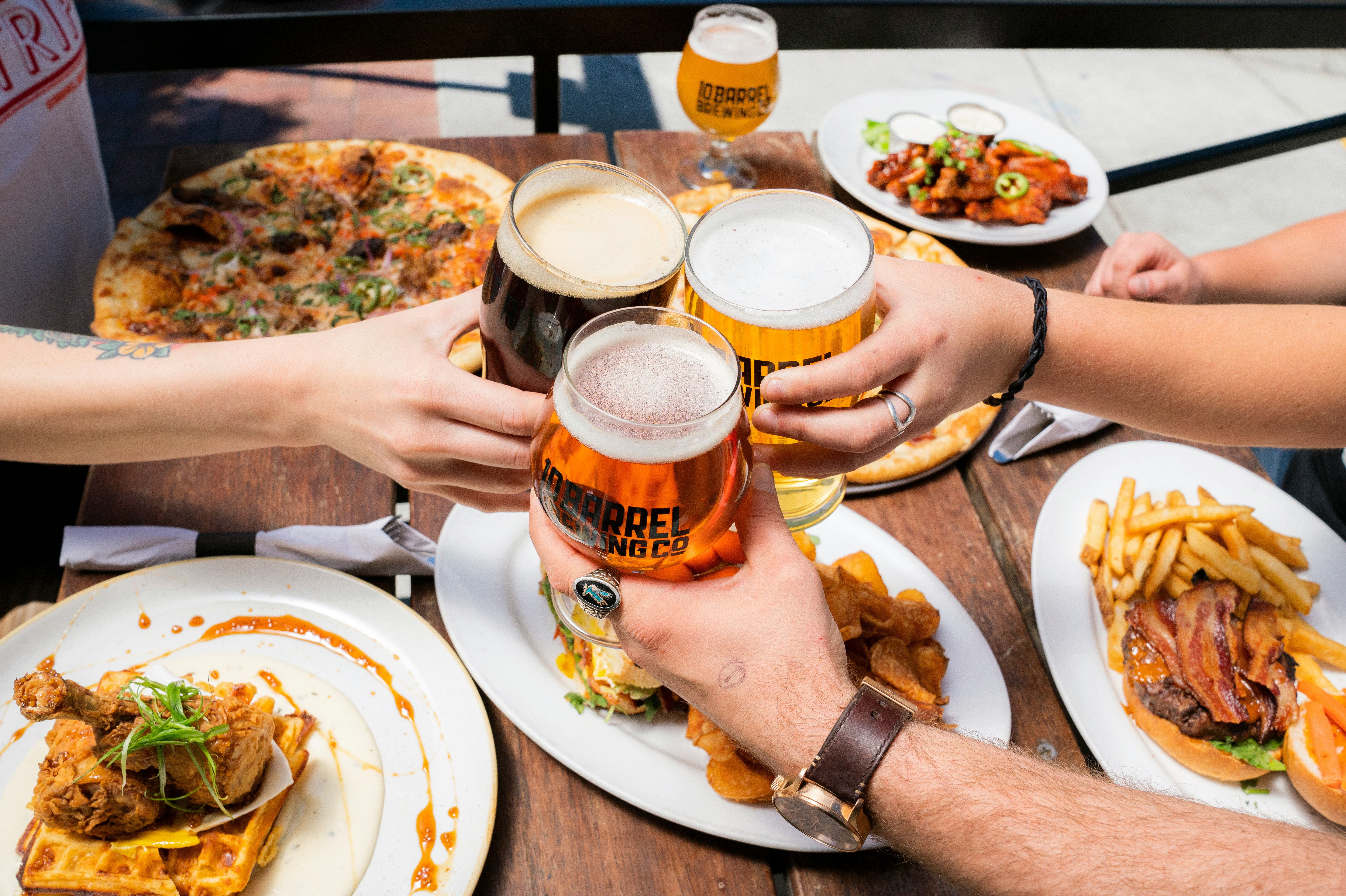 Group clinking glasses at a New Canaan bar