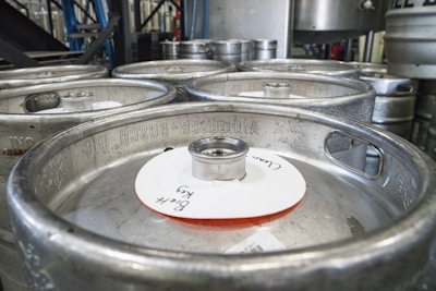 Photo of a modern production line assembling stainless steel beer kegs in a clean factory environment