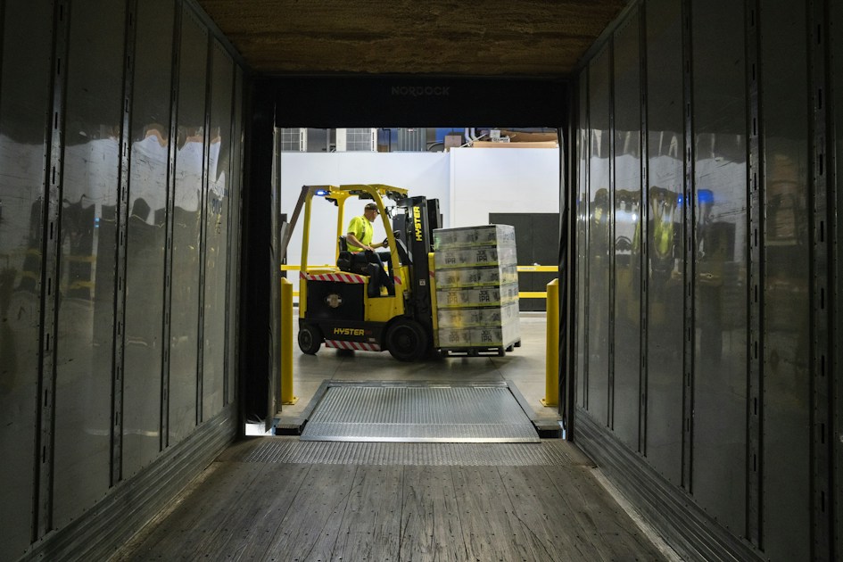 Man carrying box using fork liftr