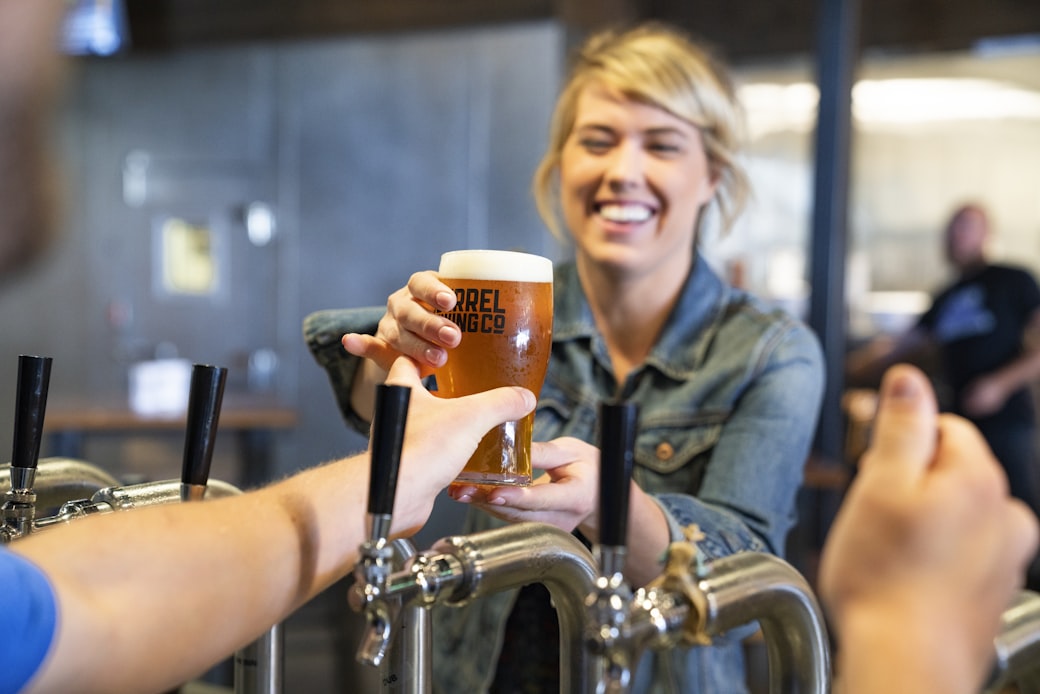 Smiling Woman Holding Clear Drinking Glass