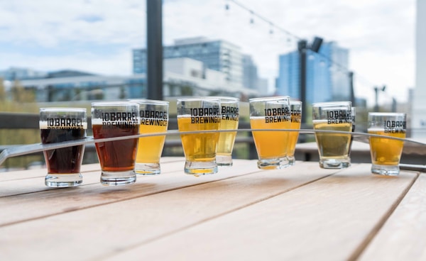 Nine clear glass cups filled beverages