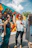 A group enjoying a wine tasting session while painting colorful murals.