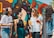 A group of friends exploring a vibrant city street, looking at a map and laughing together.