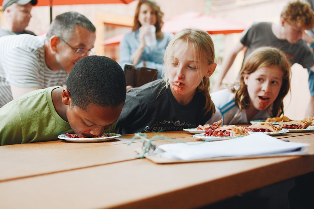 three children playing activity on table