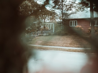 Photo capturing a suburban family home with wooden accents and a garden.