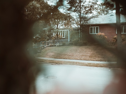 Photo capturing a suburban family home with wooden accents and a garden.