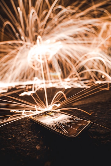 A vibrant iPhone screen showing the Shynr app adding sparkling glitter effects to a live selfie.