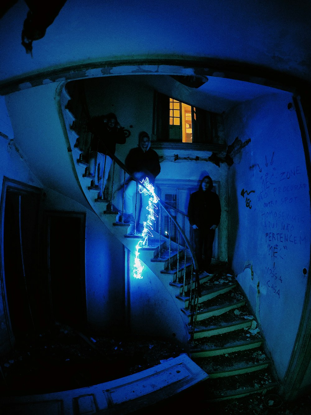 3 men standing on stairway