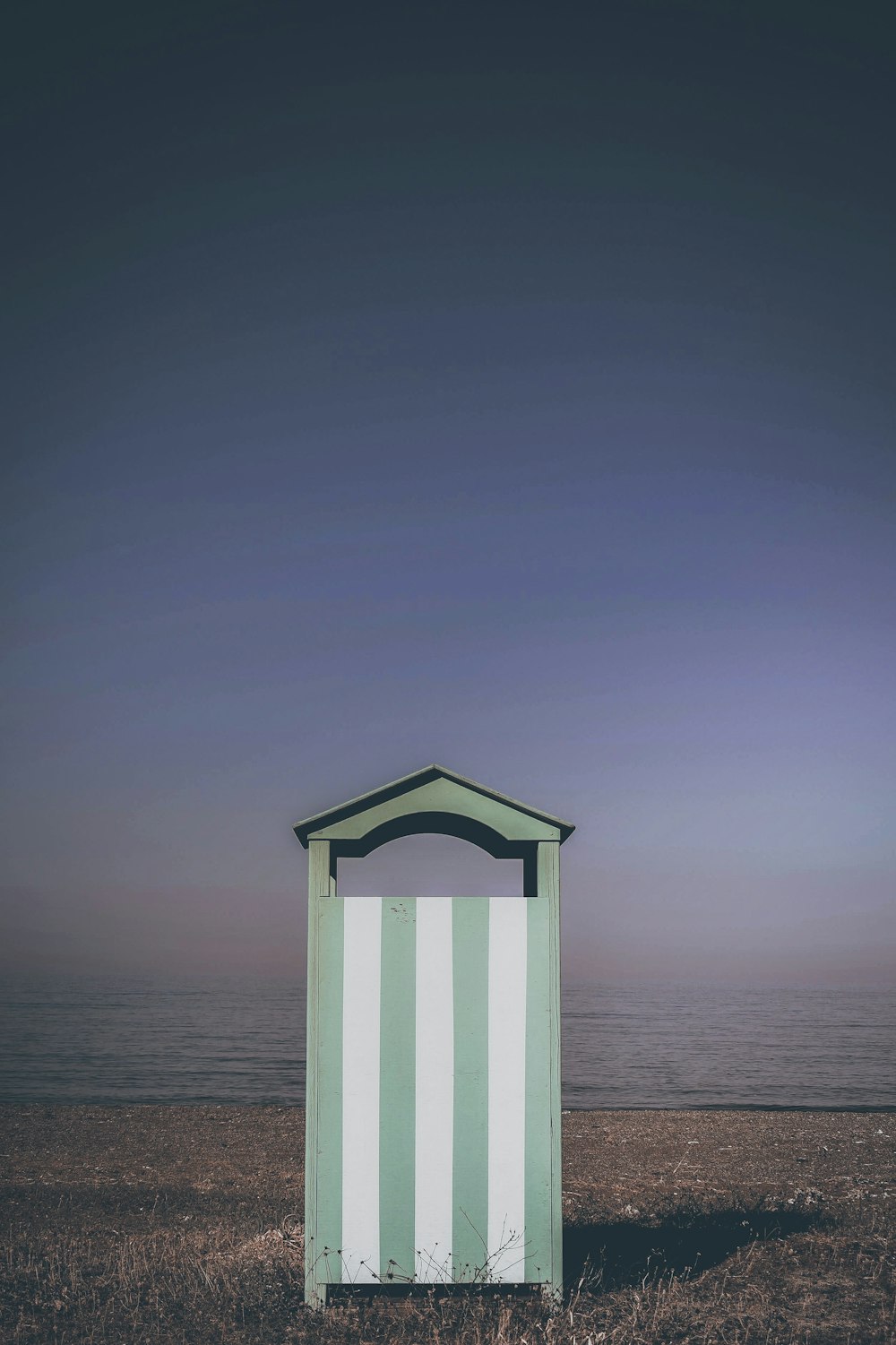 grey and white striped painted wooden shed