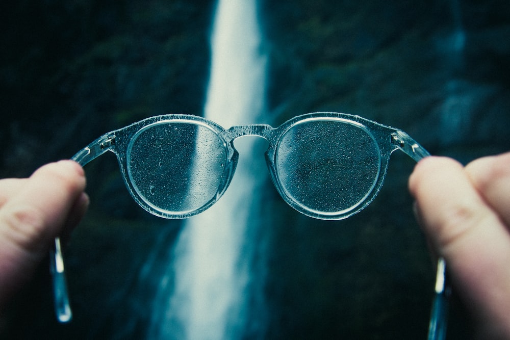 person holding eyeglasses