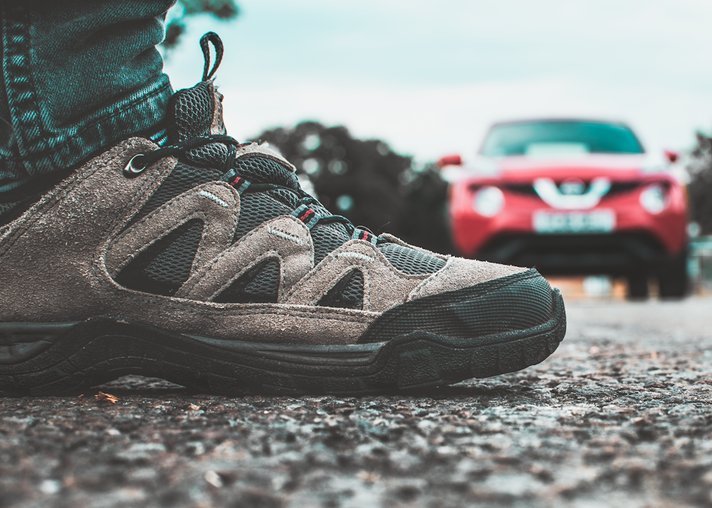 selective focus photography of brown and black hiking shoe