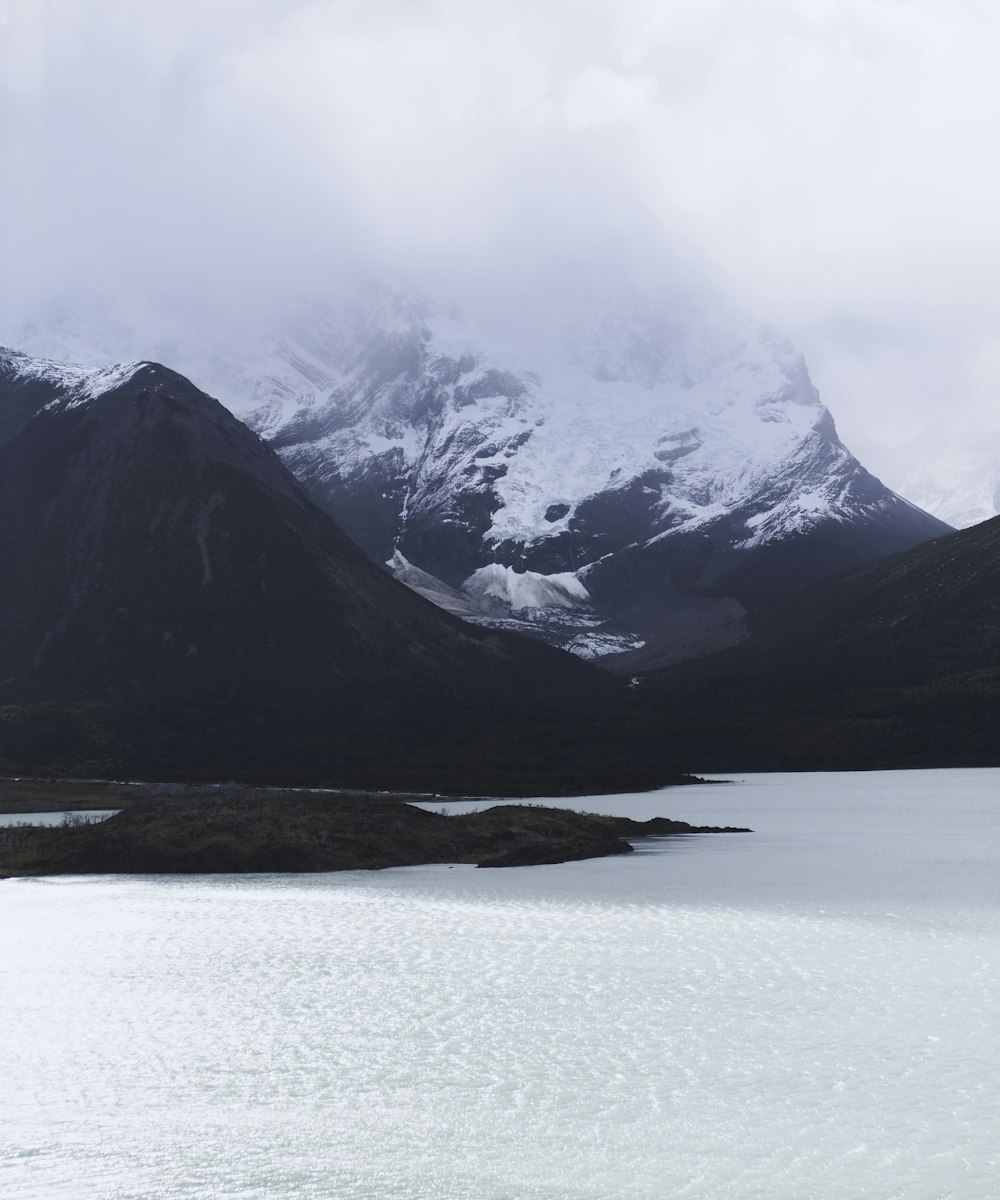 snow-capped mountain near body of water