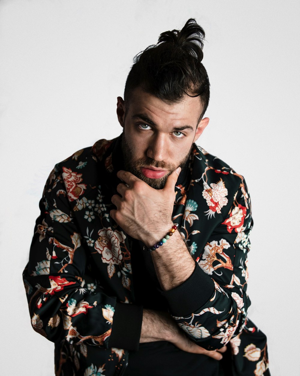 man wearing black, red, and white floral long-sleeved shirt