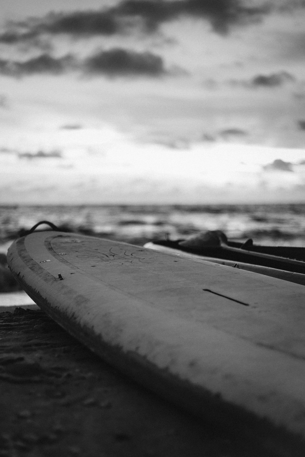 grayscale photography of surfboard