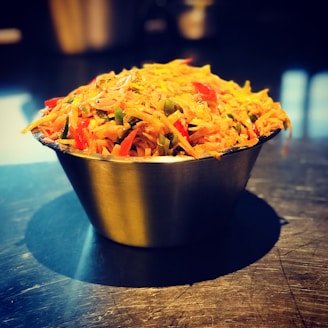 A vibrant bowl of mixed vegetable achar with mustard seeds and chili flakes.