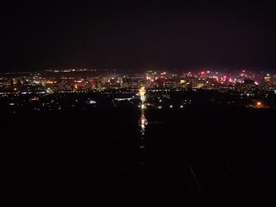 A bustling city skyline at night with bright lights and lively streets.