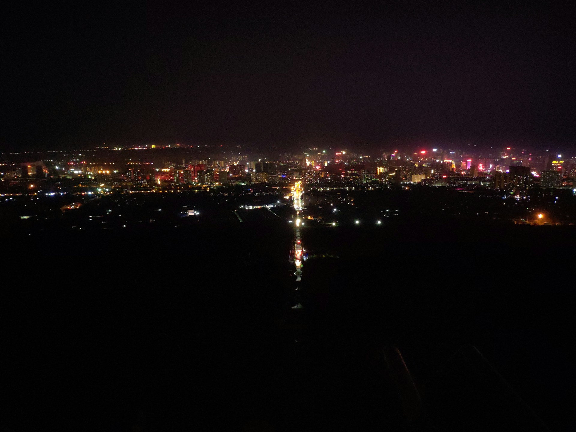 A vibrant cityscape at night, illuminated by thousands of lights.