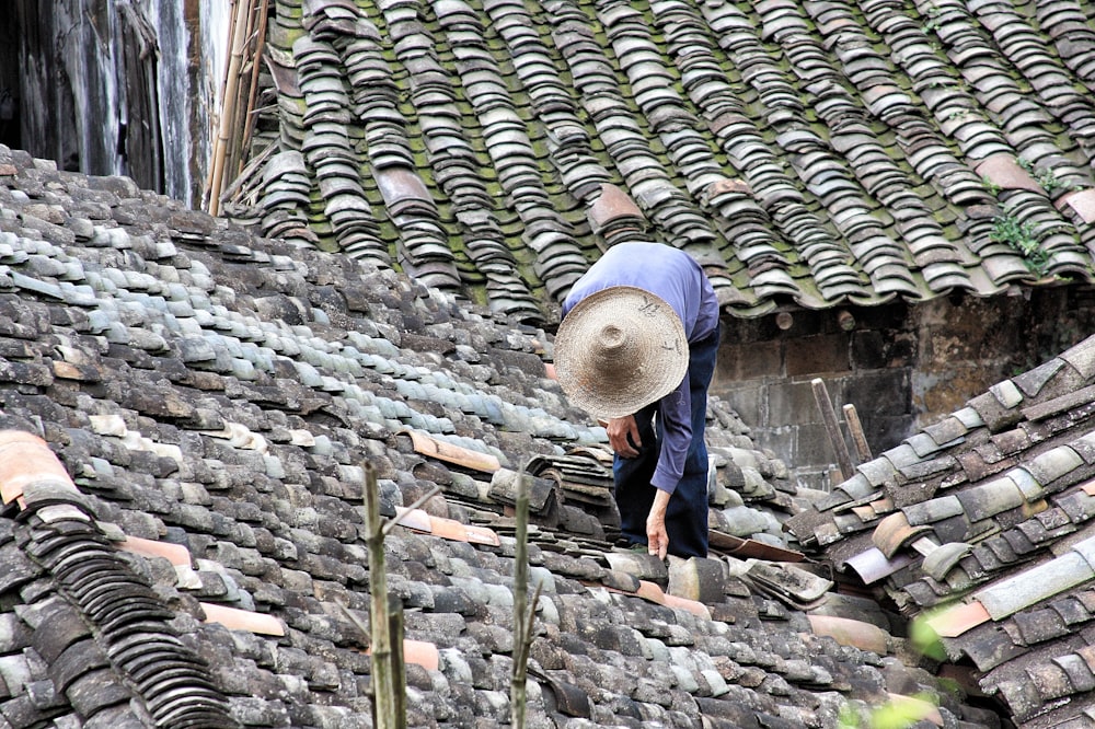 person standing on roof tiles