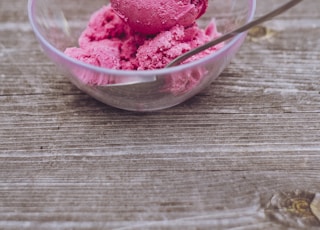 strawberry ice cream in clear glass bowl