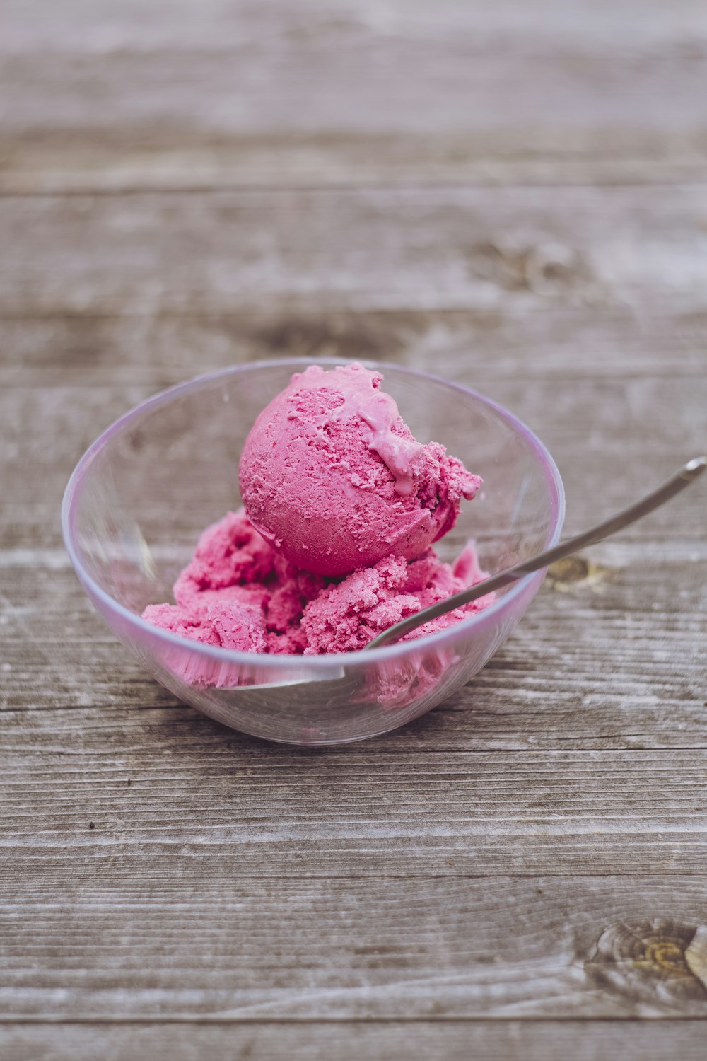 strawberry ice cream in clear glass bowl