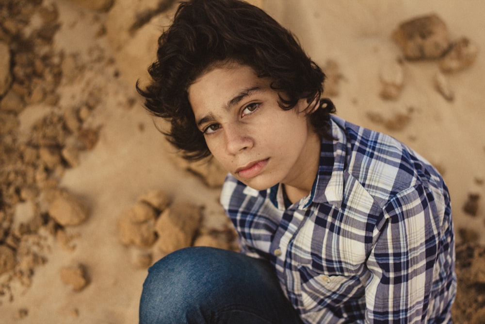 man in blue, gray, and white plaid sport shirt