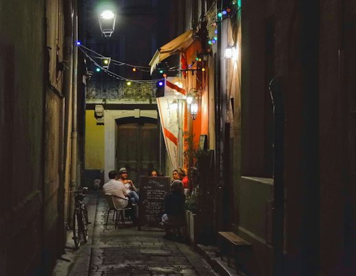 A café table in a lane at night — Arles, France