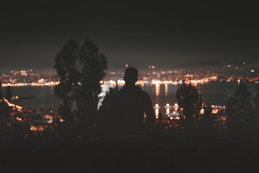 silhouette of man facing in front of building