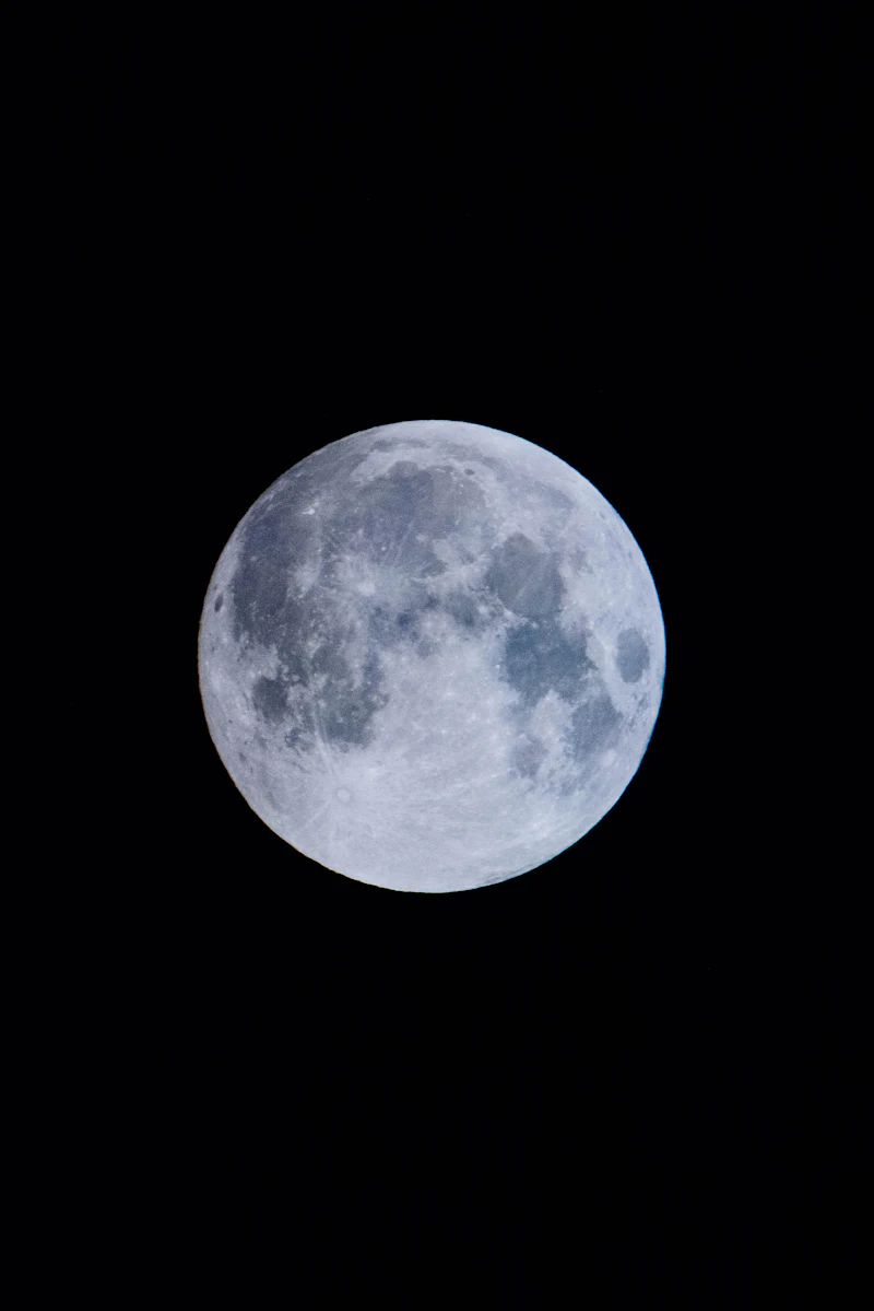 A full moon in a dark night sky