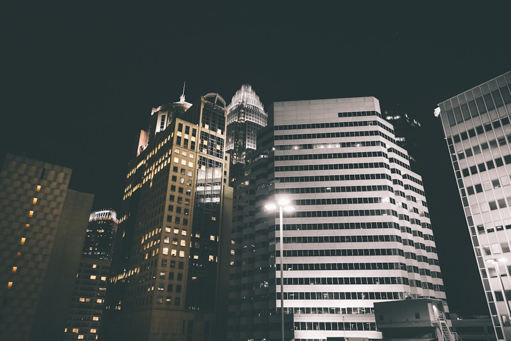 low angle photography of concrete buildings at night