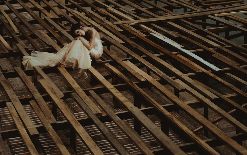 woman laying down on wooden structure