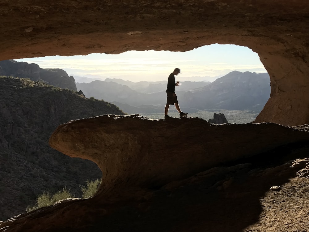 man walking on rock formation