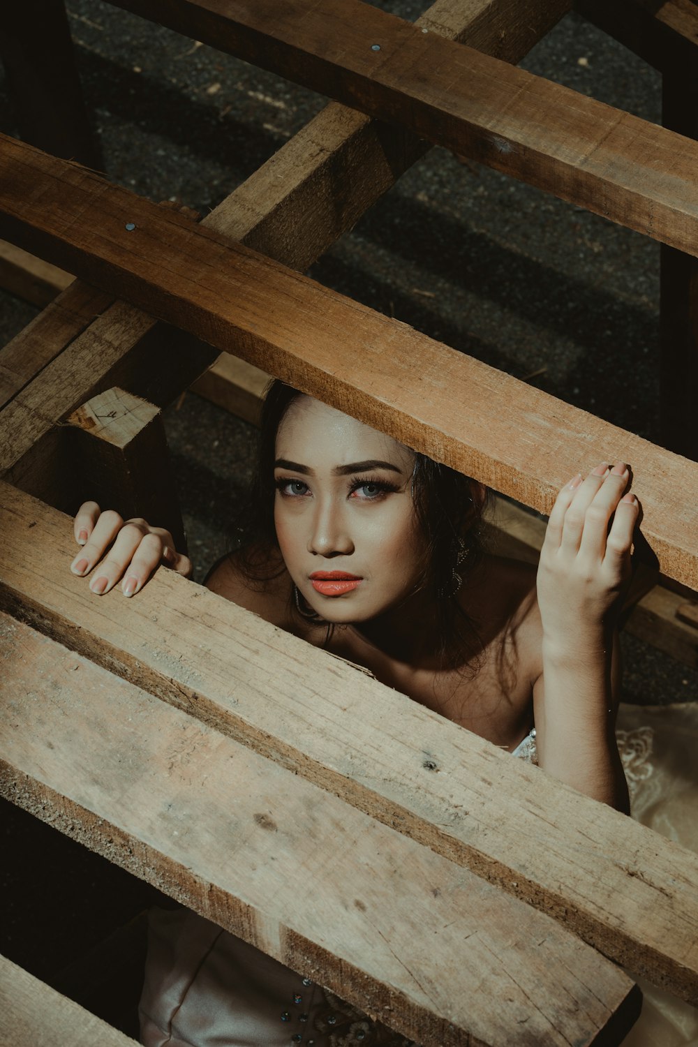woman below brown wooden frames