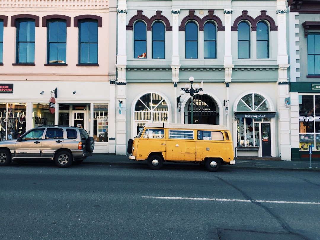 yellow van behind silver SUV,