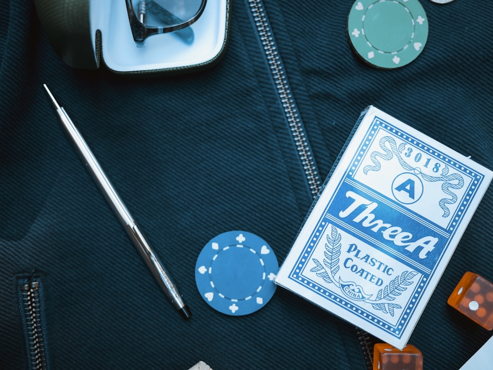 poker chip beside playing card box