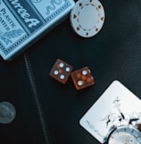 two orange dice on black surface