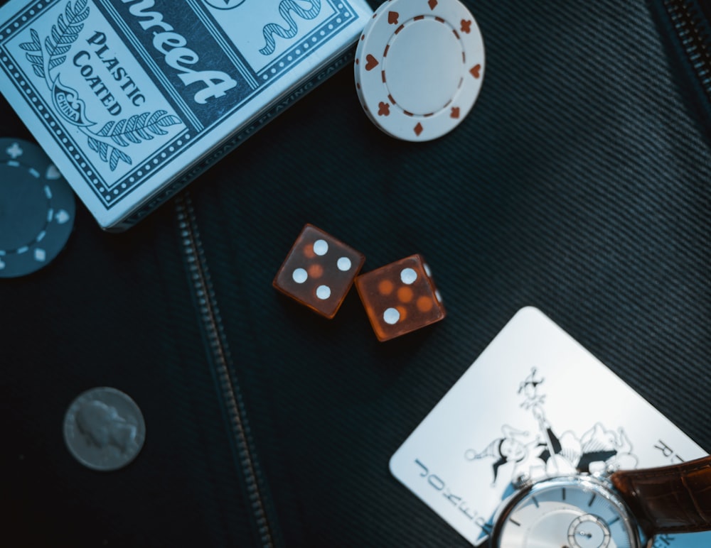 two orange dice on black surface