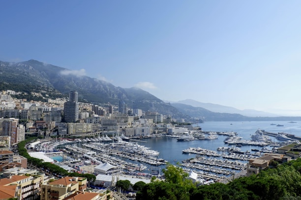 A scenic view of Sainte Maxime coastline with crystal clear water and luxurious yachts docked.