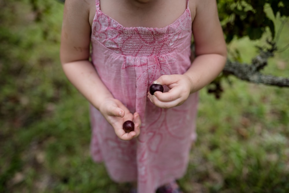 girl wearing pink spaghetti strap dress