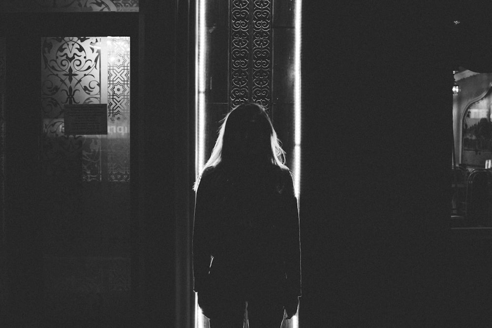 woman standing near door inside room