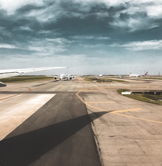 photo of white airplane on runway