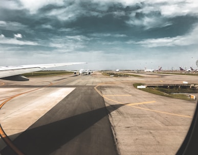 photo of white airplane on runway