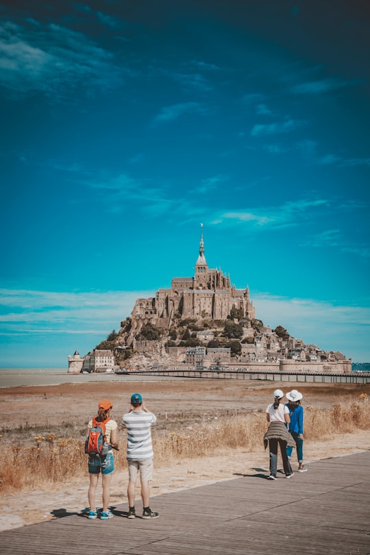 landscape photo of citadel under blue sky in Mont Saint-Michel France