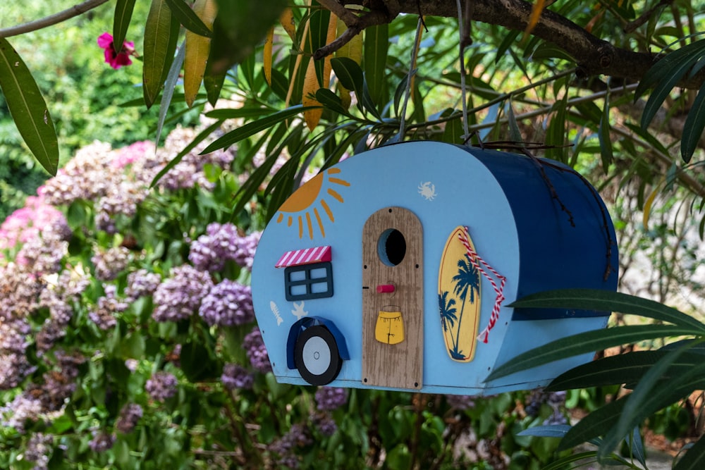 blue and multicolored wooden bird house